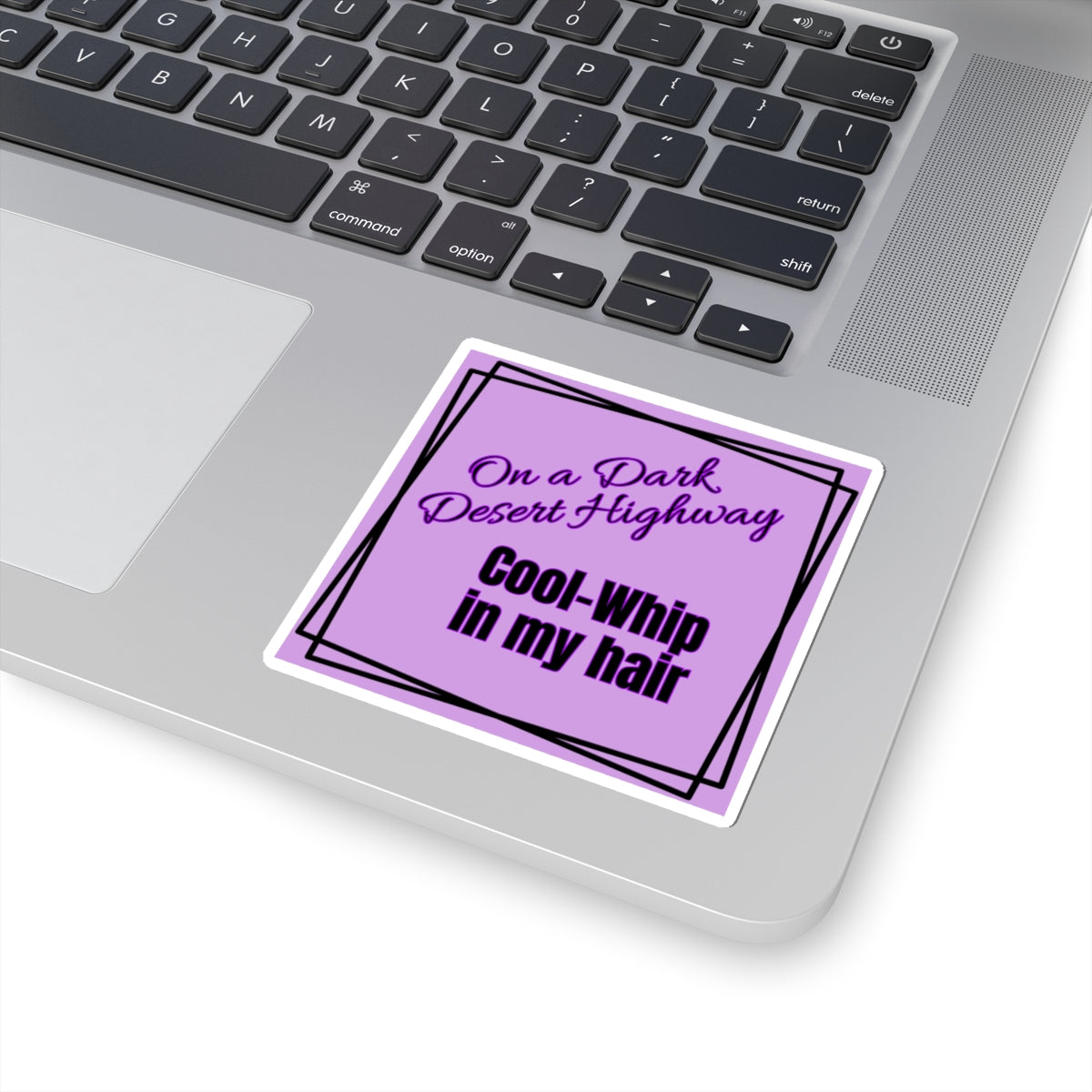 Purple sticker with text on a laptop