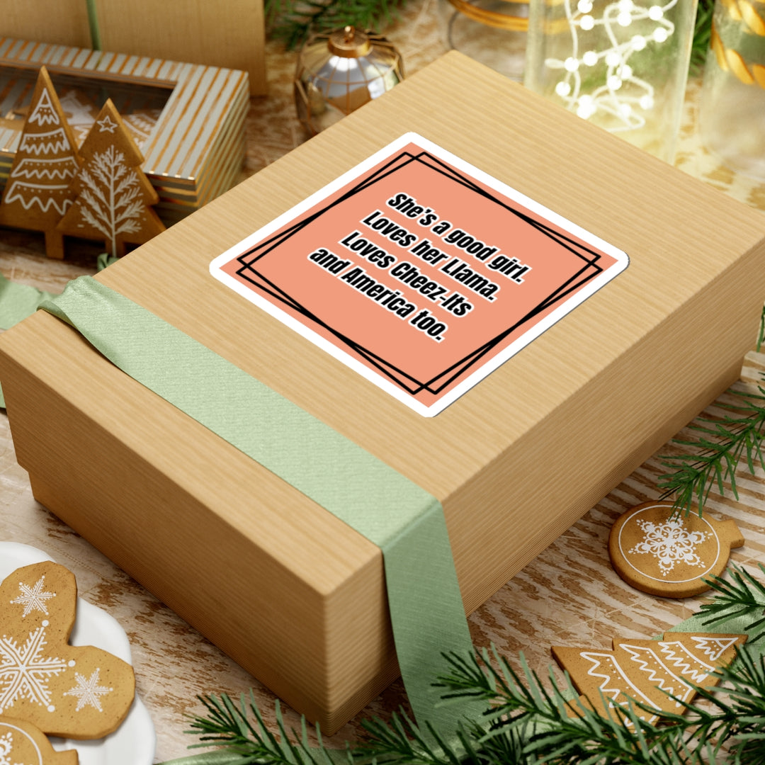 Gift box with a card on top, surrounded by Christmas decorations