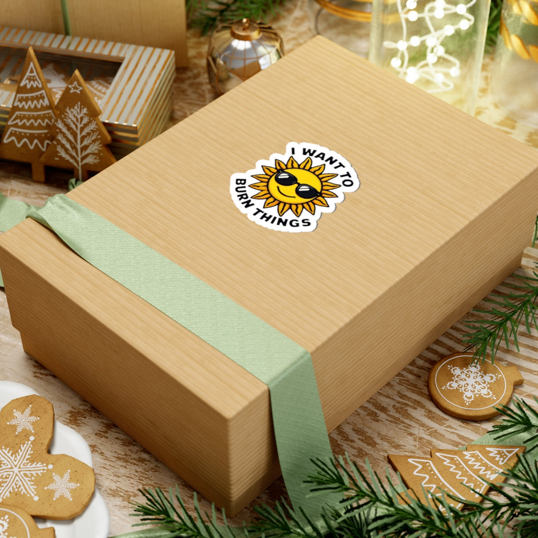 Gift box with a sun-themed sticker on a festive background with cookies and greenery