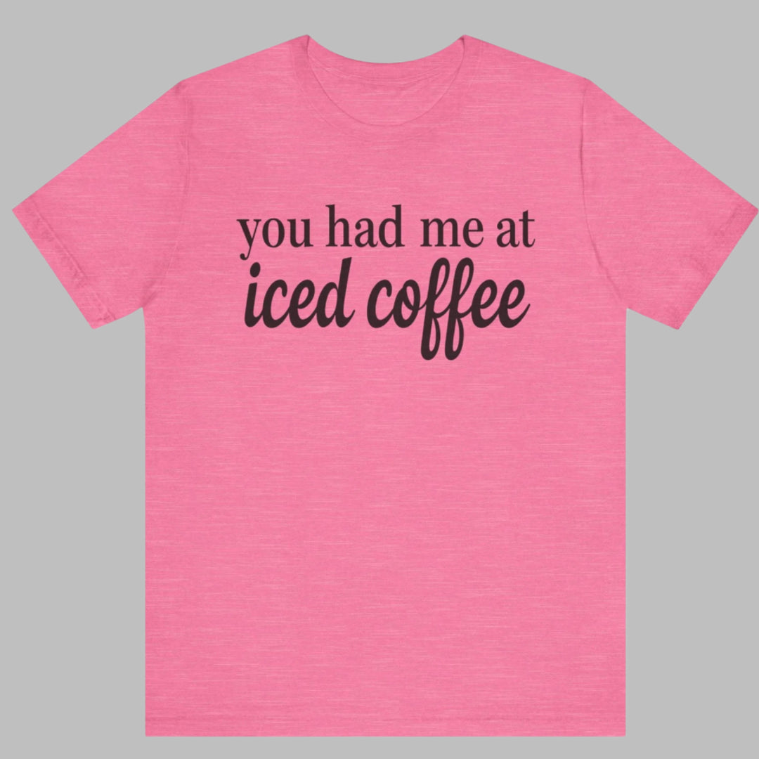 Pink t-shirt with 'you had me at iced coffee' text on a white background