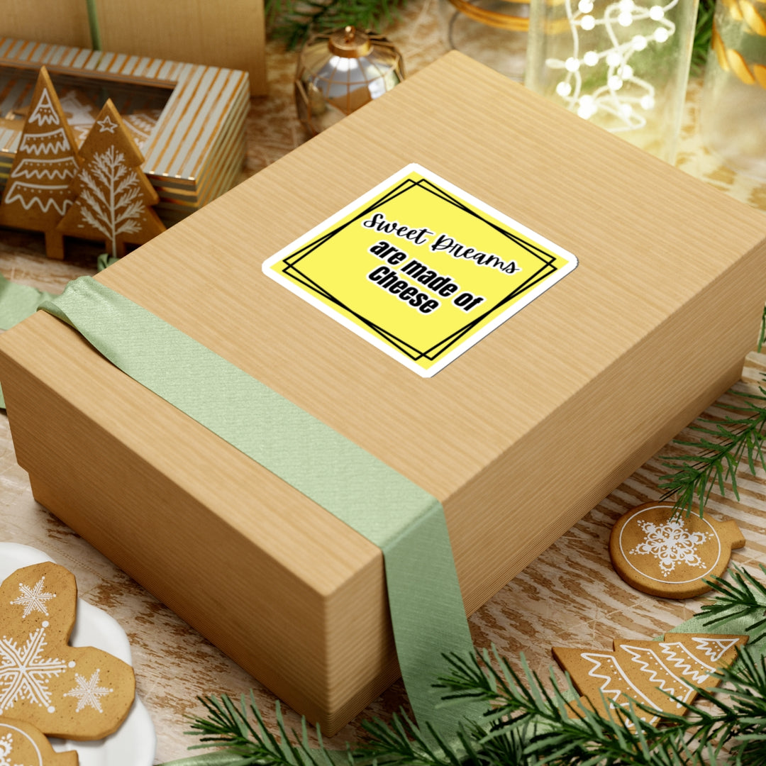 Wooden gift box with a yellow label and green ribbon, surrounded by Christmas-themed cookies and decorations.