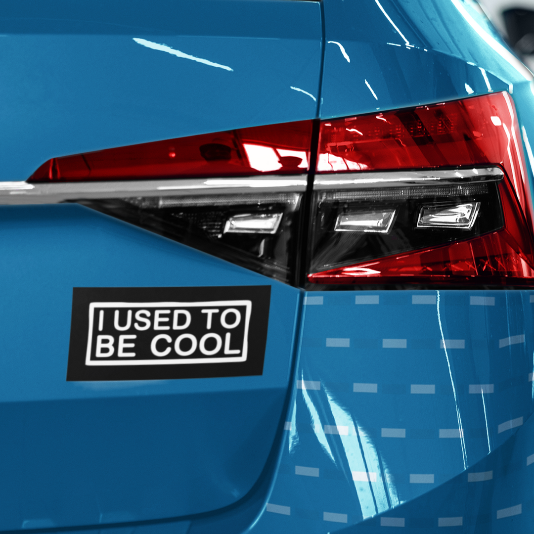 Blue car with a 'I used to be cool' sticker on the back