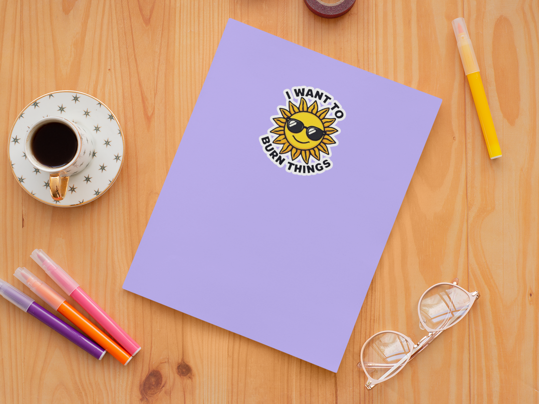 Purple notebook with a sun illustration and text on a wooden surface with stationery items.