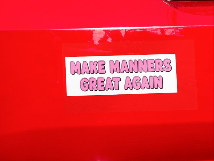 Red car with a 'Make Manners Great Again' sticker on the trunk.