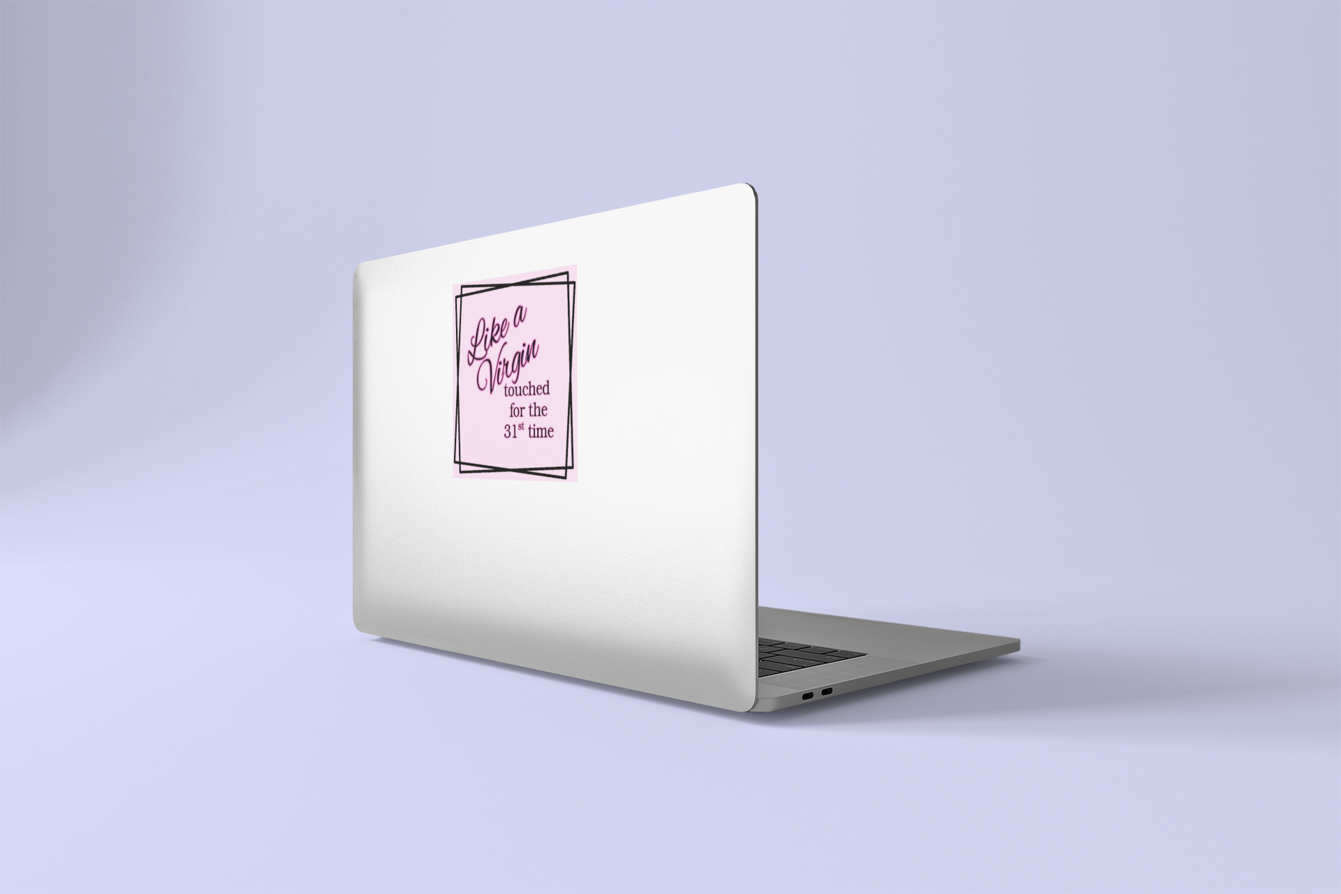 Laptop with a pink Like a Virgin sticker on a light purple background
