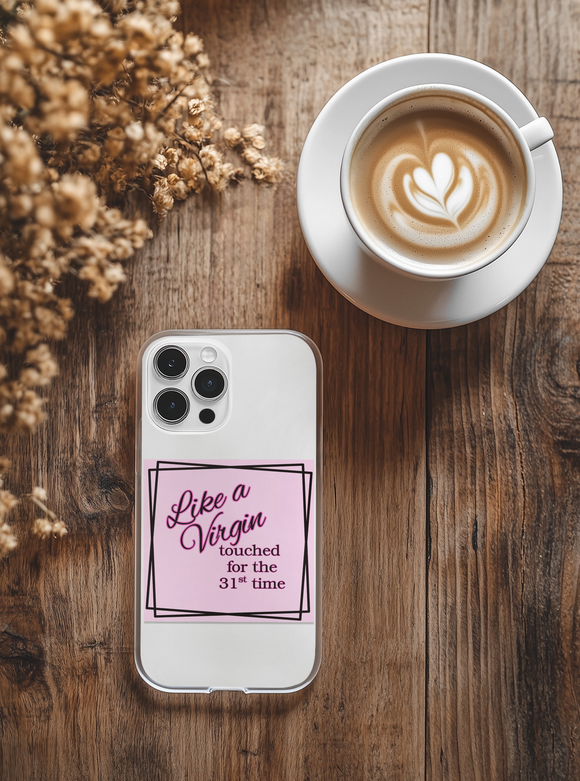 Phone case with Like a Virgin text on a wooden table with a cup of coffee