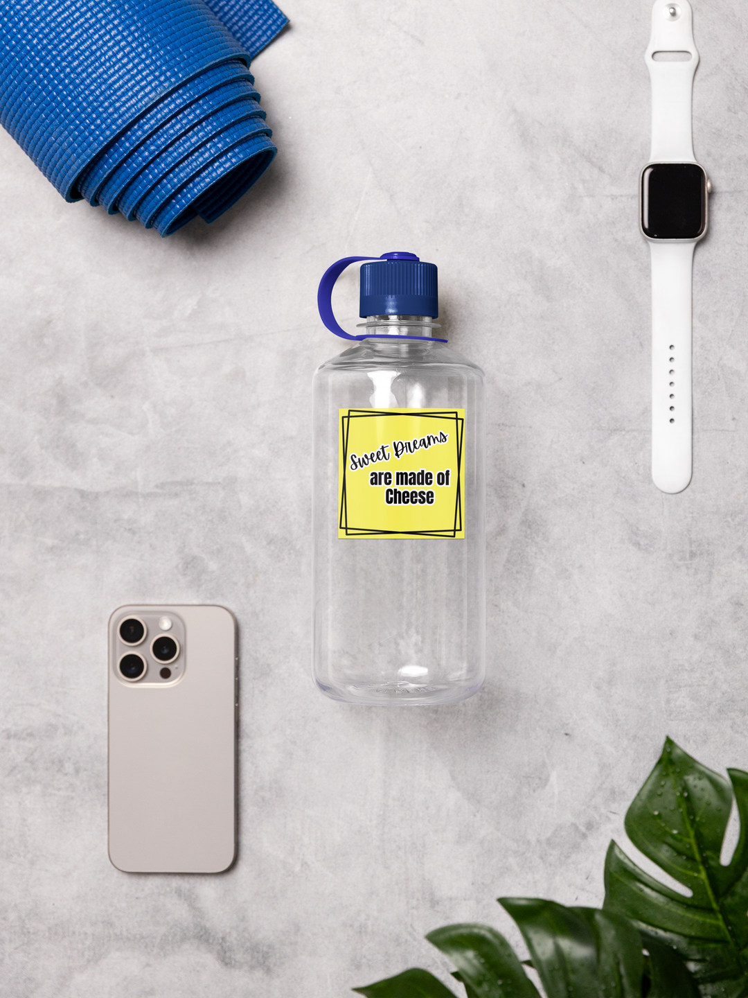 Clear water bottle with a yellow label, phone, yoga mat, and smartwatch on a gray surface.