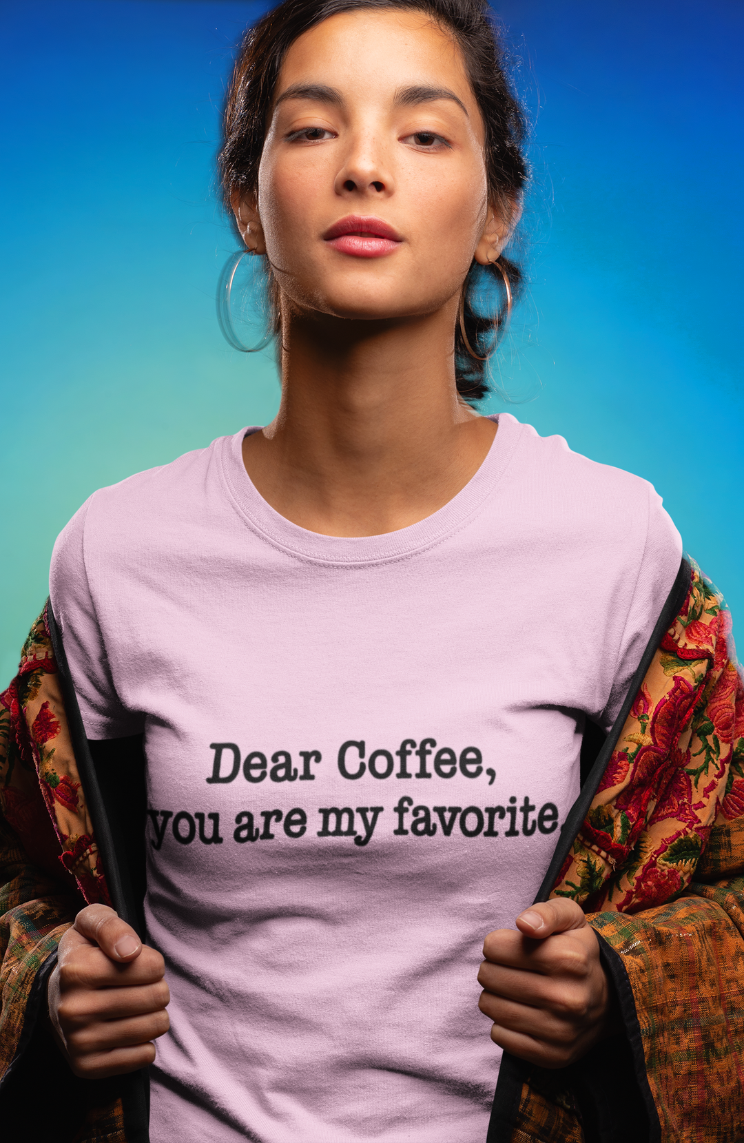 Person wearing a t-shirt with 'Dear Coffee, you are my favorite' text against a blue gradient background