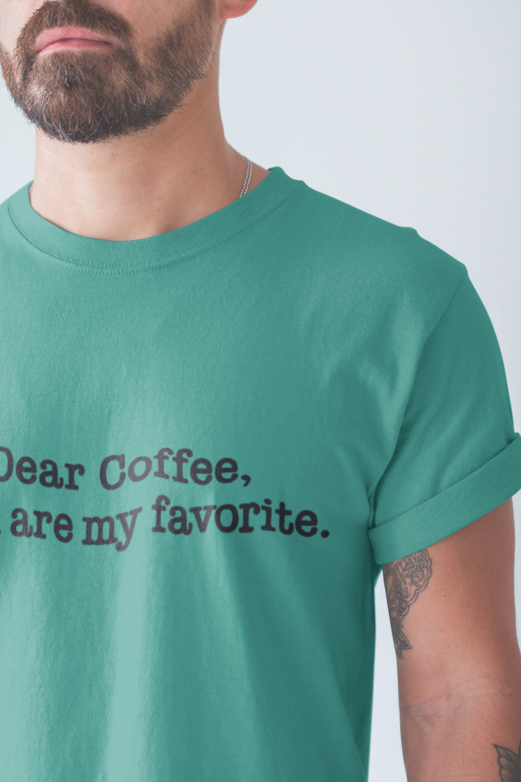 Person wearing a green t-shirt with text 'Dear Coffee, are my favorite.' on a plain background