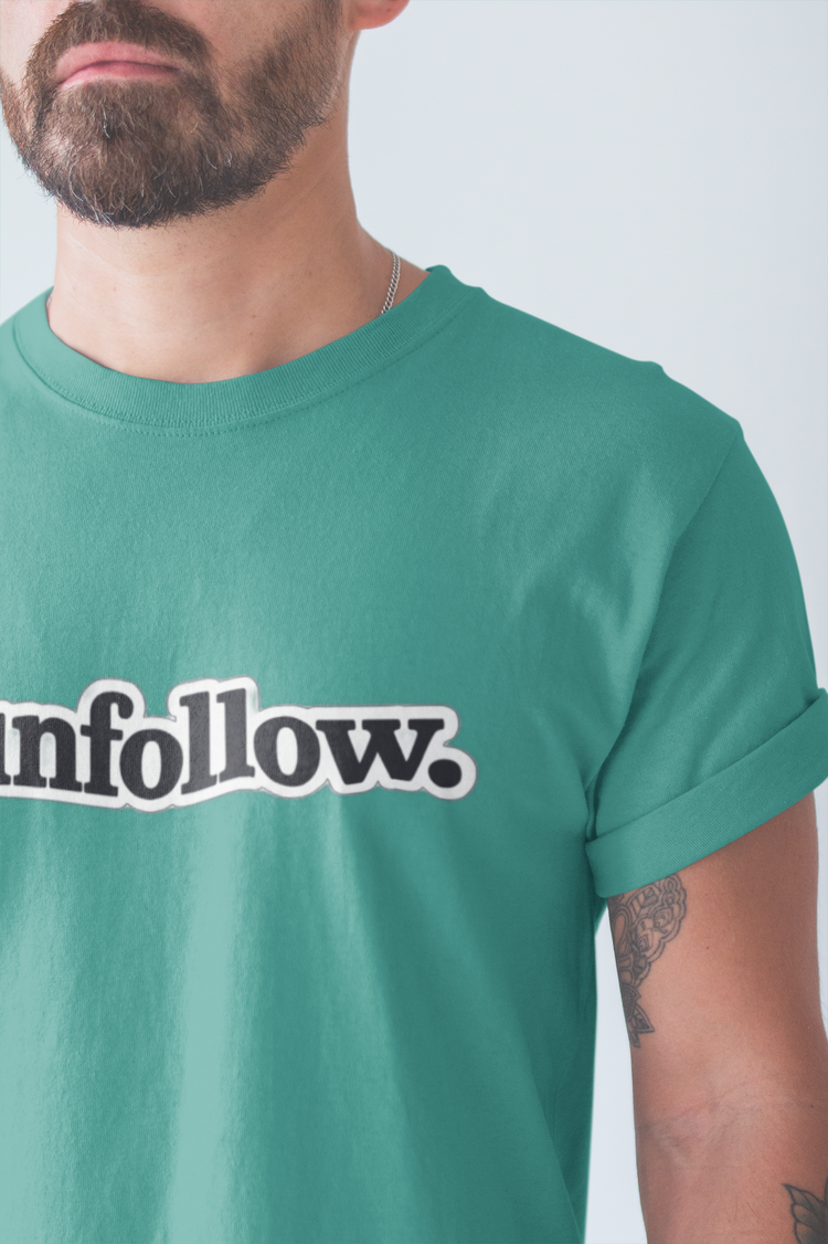Person wearing a green t-shirt with 'unfollow.' printed on it against a plain background
