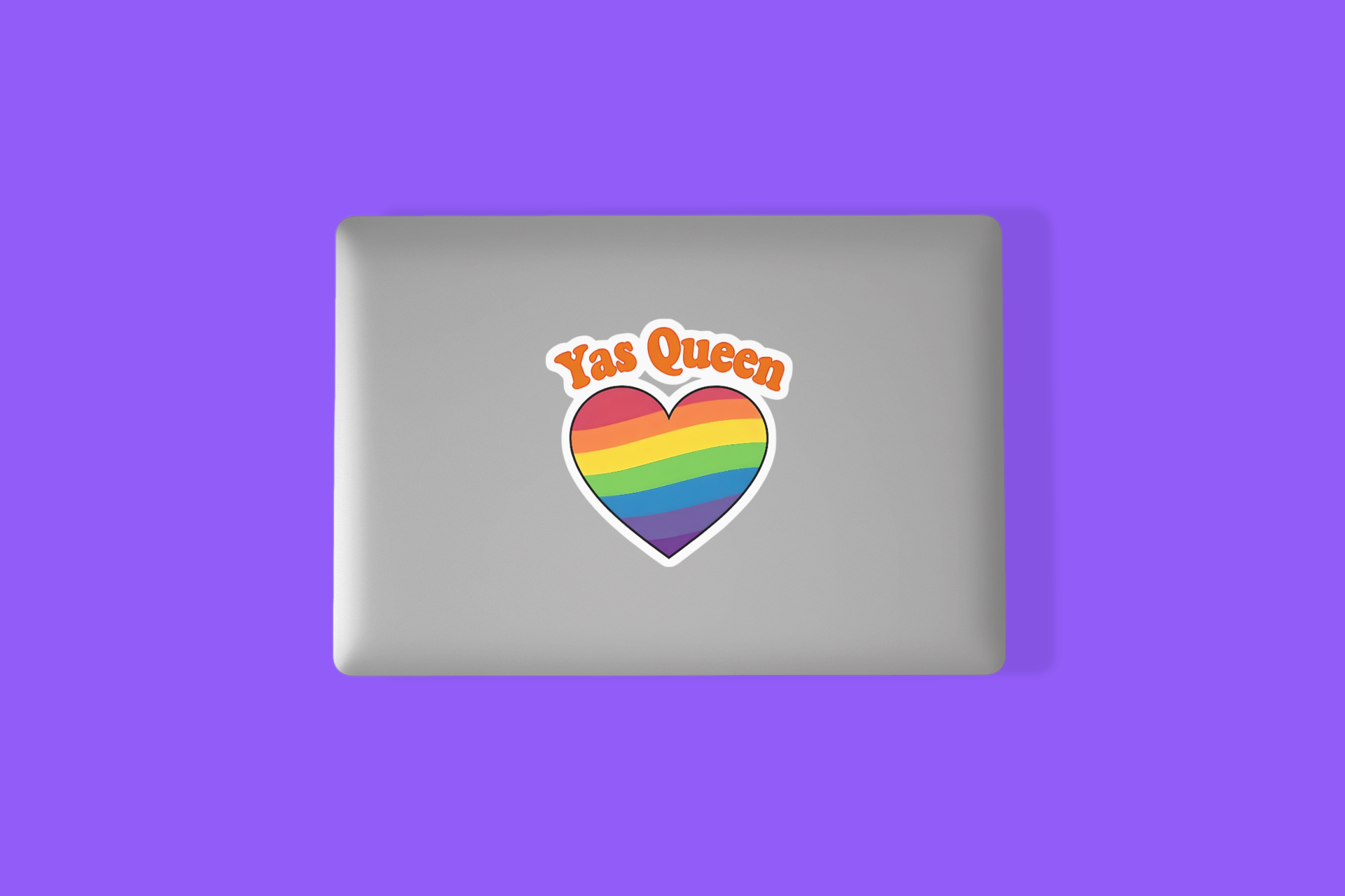 Sticker with rainbow heart and 'Yas Queen' text on a silver laptop against a purple background