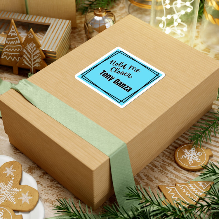 Wooden gift box with a blue label on a festive background with cookies and greenery