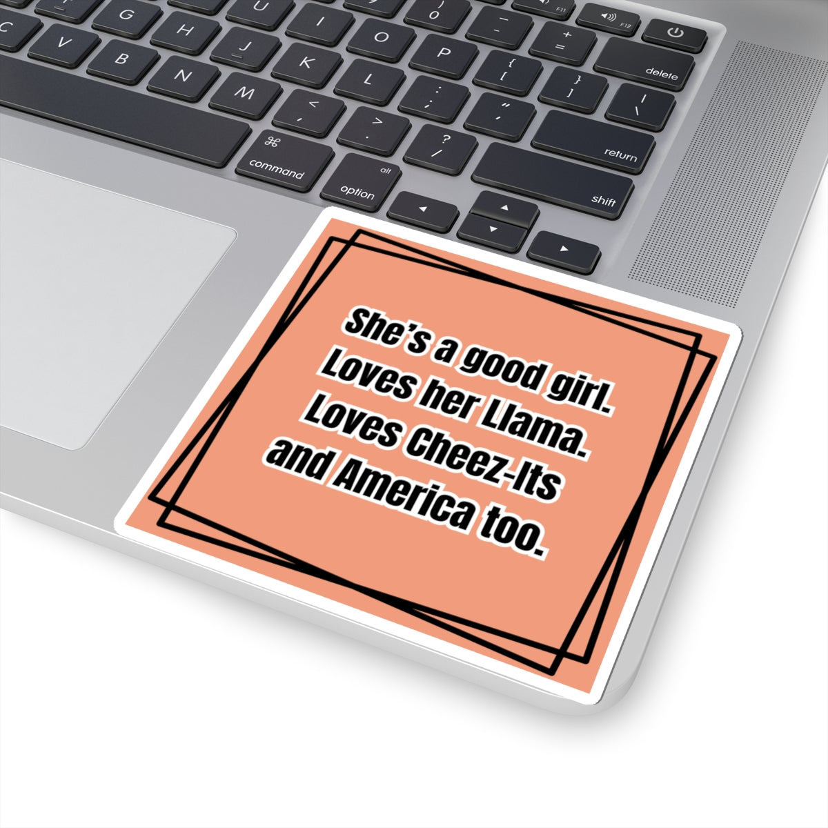 Laptop with a sticker on the palm rest area featuring text.