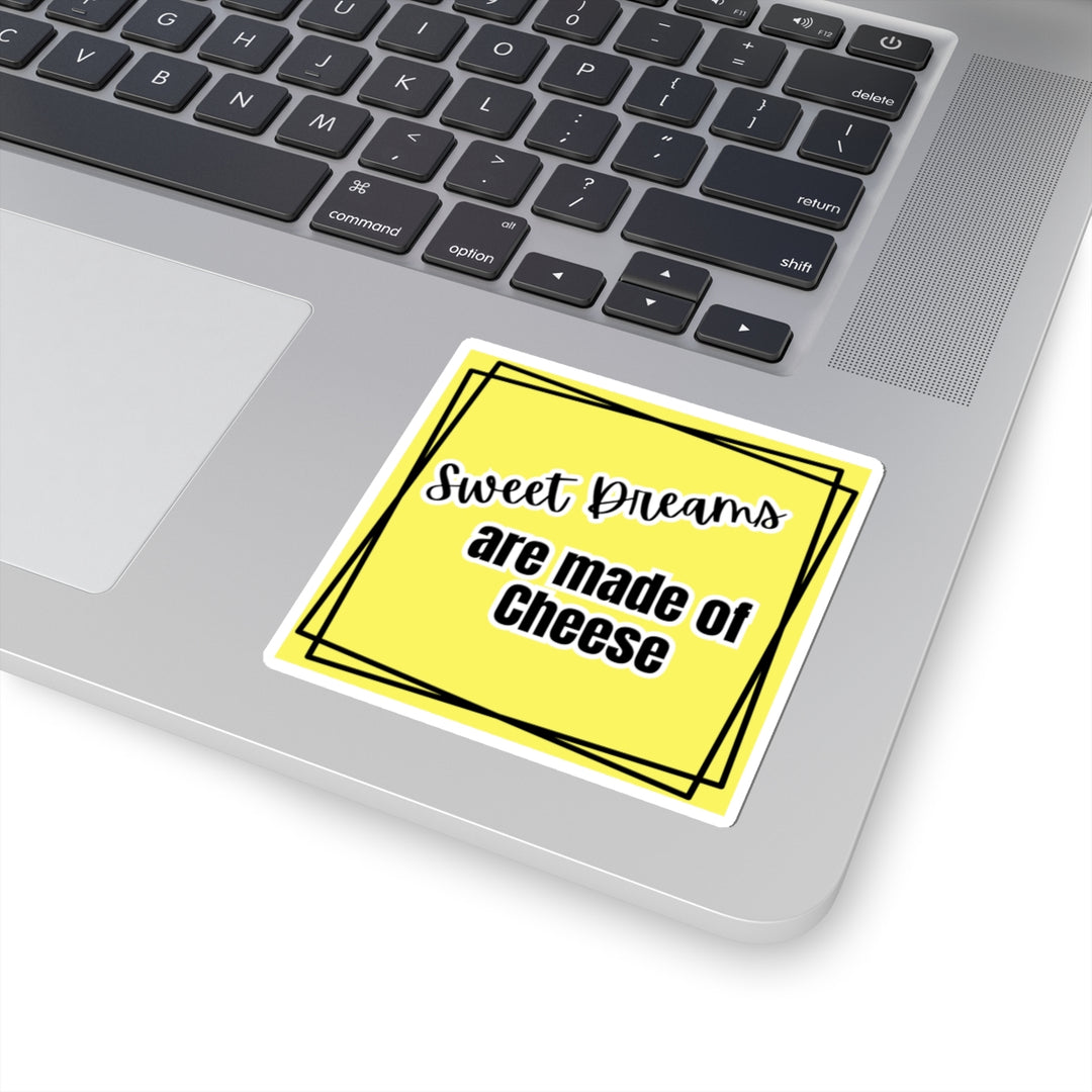 Yellow sticker with 'Sweet Dreams are made of Cheese' text on a laptop