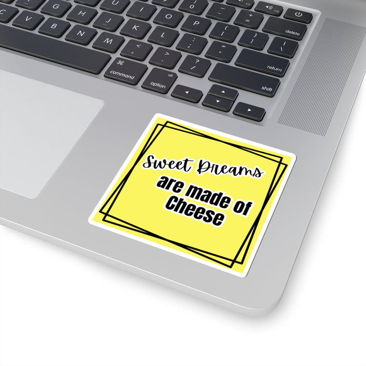 Yellow sticker with 'Sweet Dreams are made of Cheese' text on a laptop