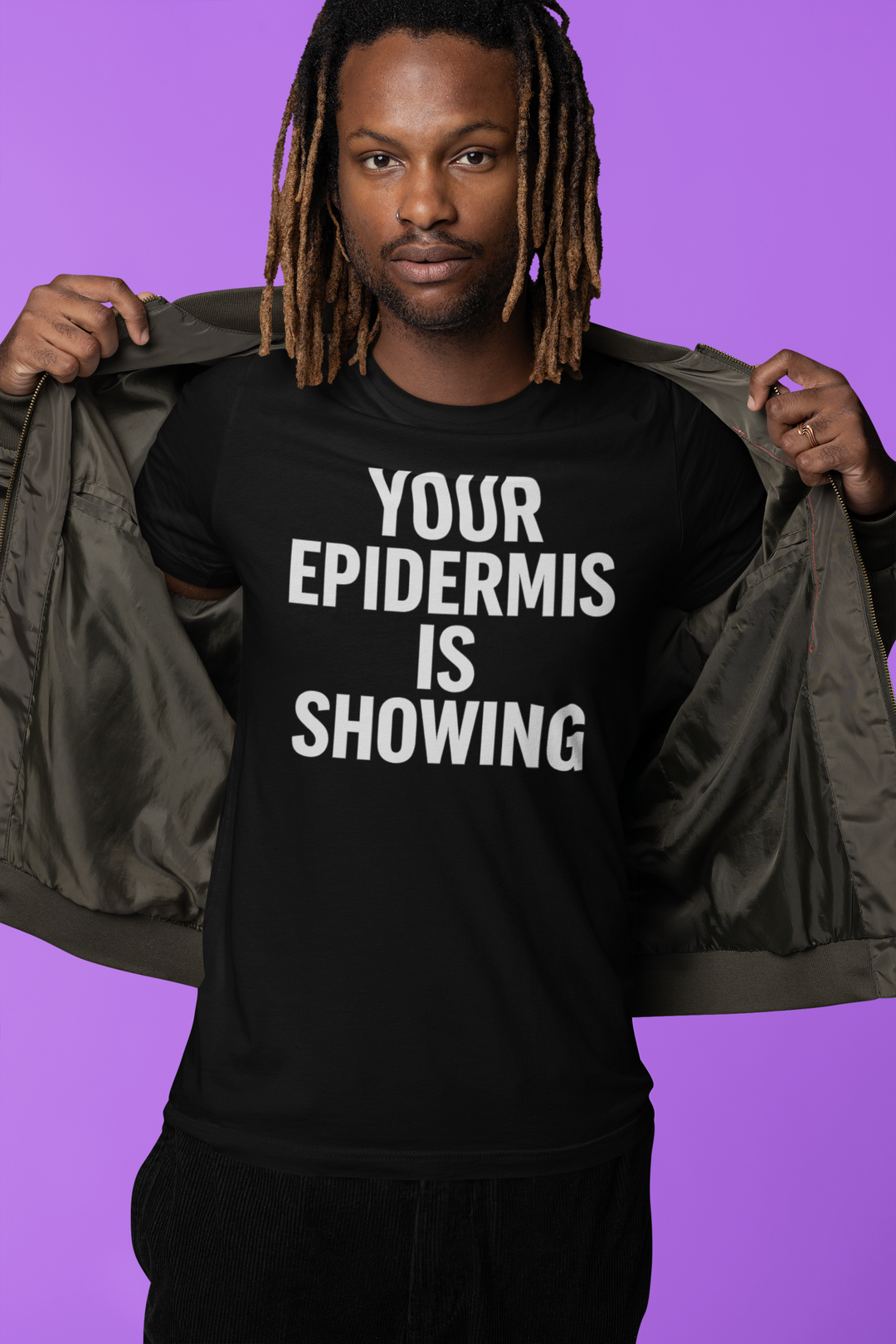 Person wearing a black t-shirt with 'Your Epidermis is Showing' text against a purple background