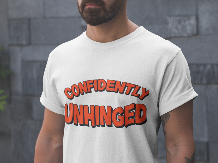 Man wearing a white t-shirt with 'CONFIDENTLY UNHINGED' text in red and black.