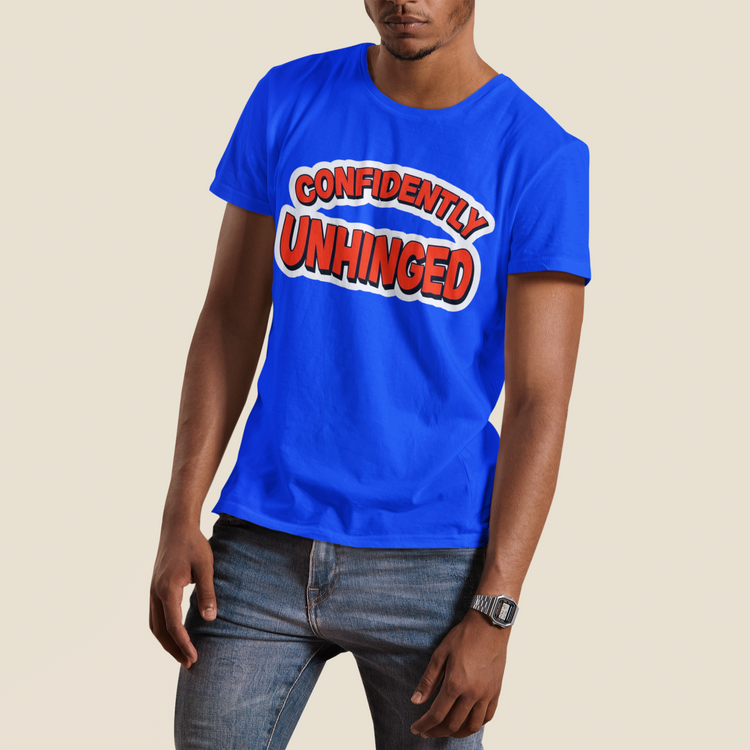 Person wearing a blue t-shirt with 'CONFIDENTLY UNHINGED' text on a beige background