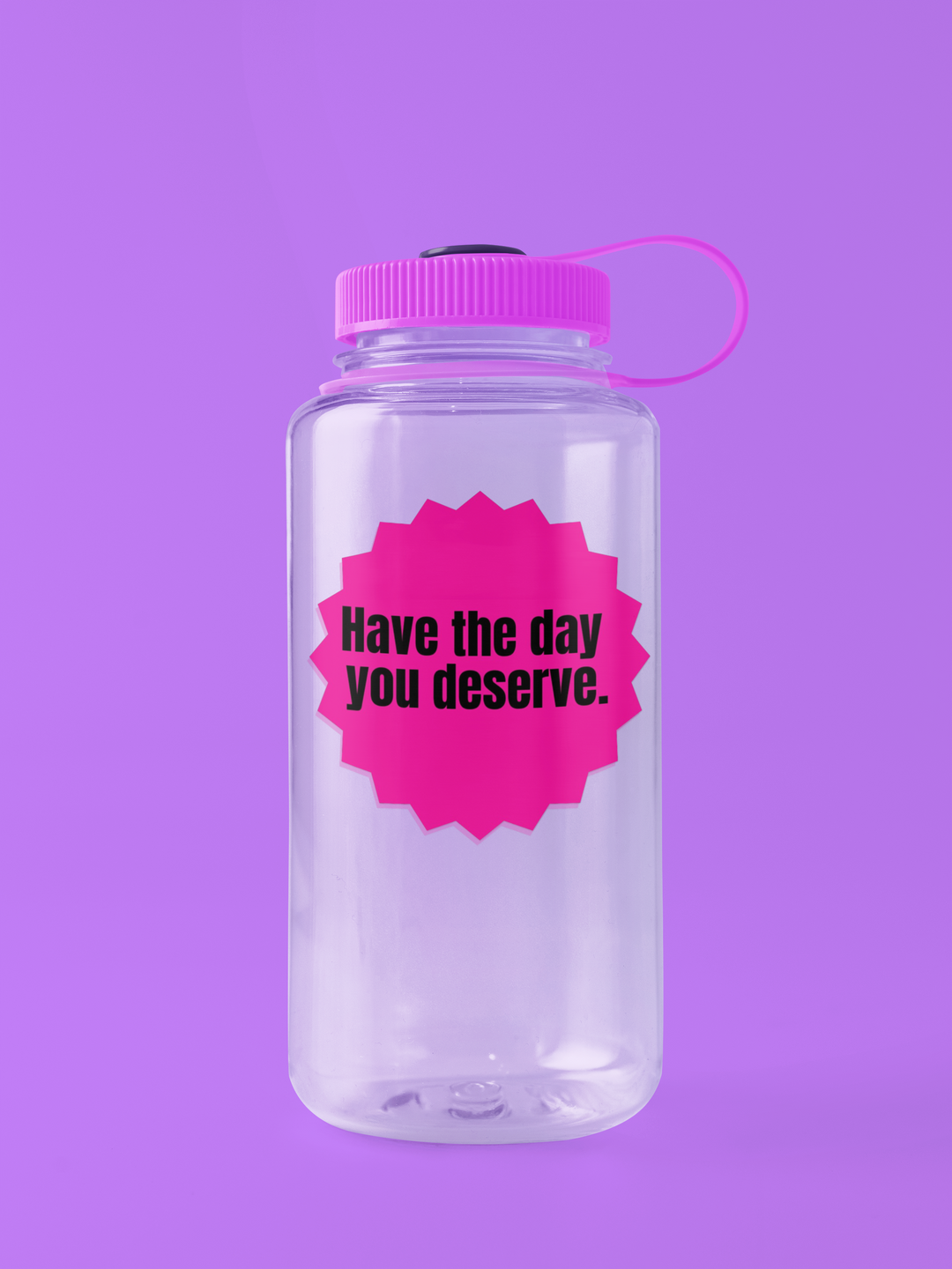 Clear water bottle with pink lid and Pink "have the day you deserve" sticker on a purple background