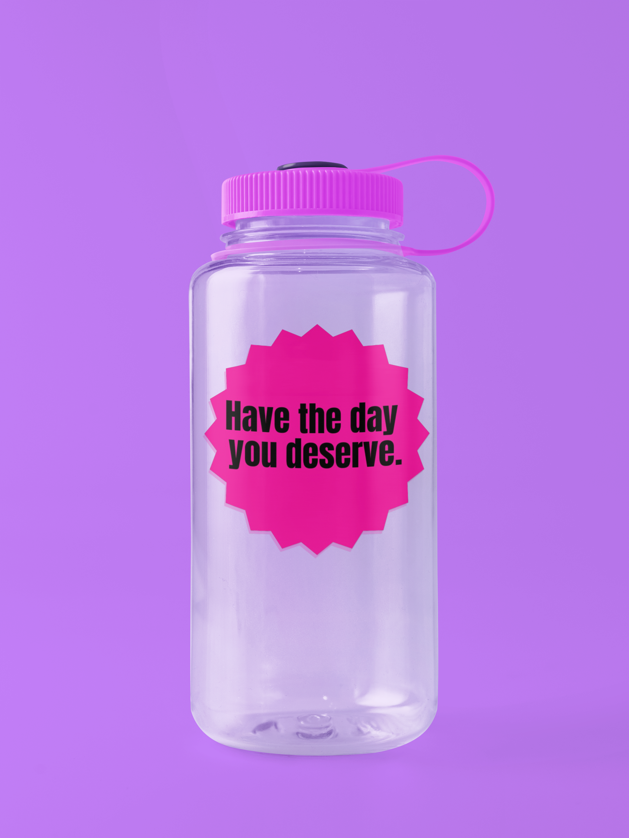 Clear water bottle with pink lid and Pink "have the day you deserve" sticker on a purple background