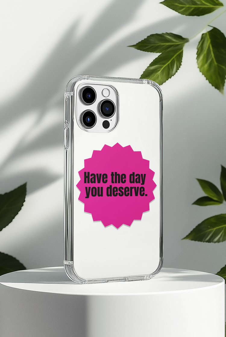 Phone case with "Have the Day You Deserve" quote on a white background with leaves