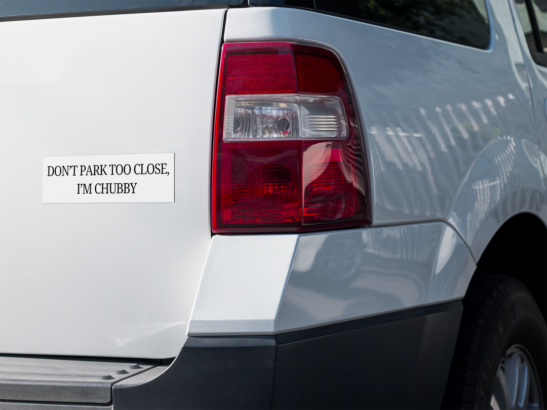 Car tail light with a humorous sticker, Don't Park Too Close, I'm Chubby" on a white background