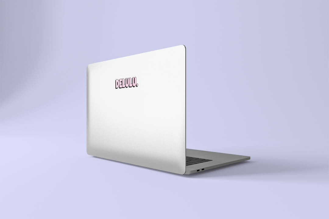 Silver laptop with a DELULU on a light purple background.