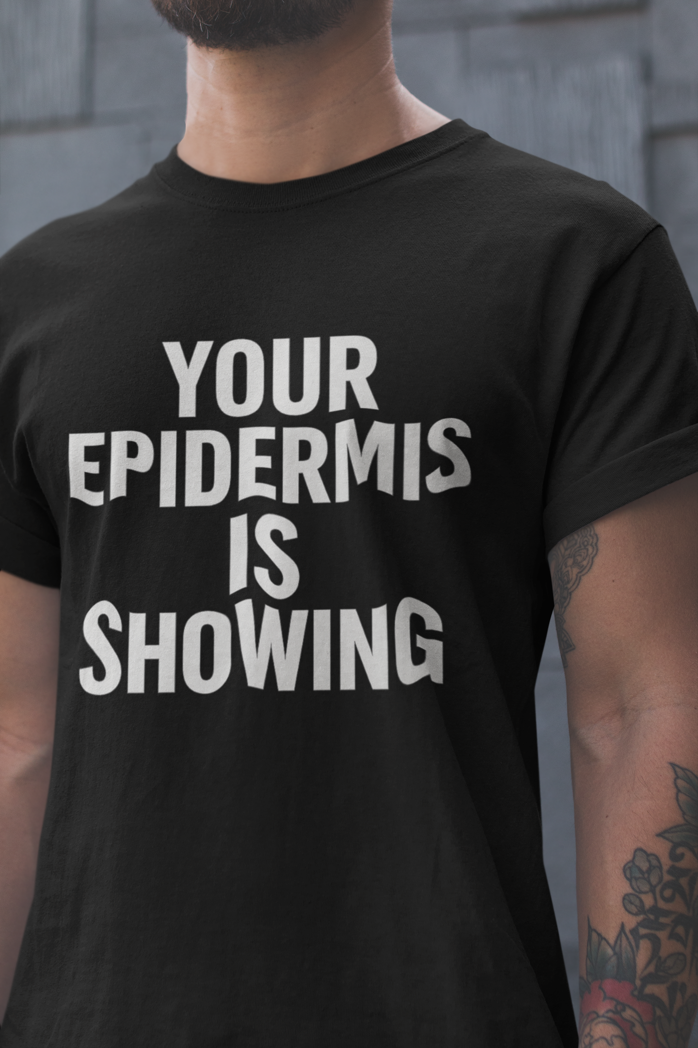 Person wearing a black t-shirt with 'YOUR EPIDERMIS IS SHOWING' text.