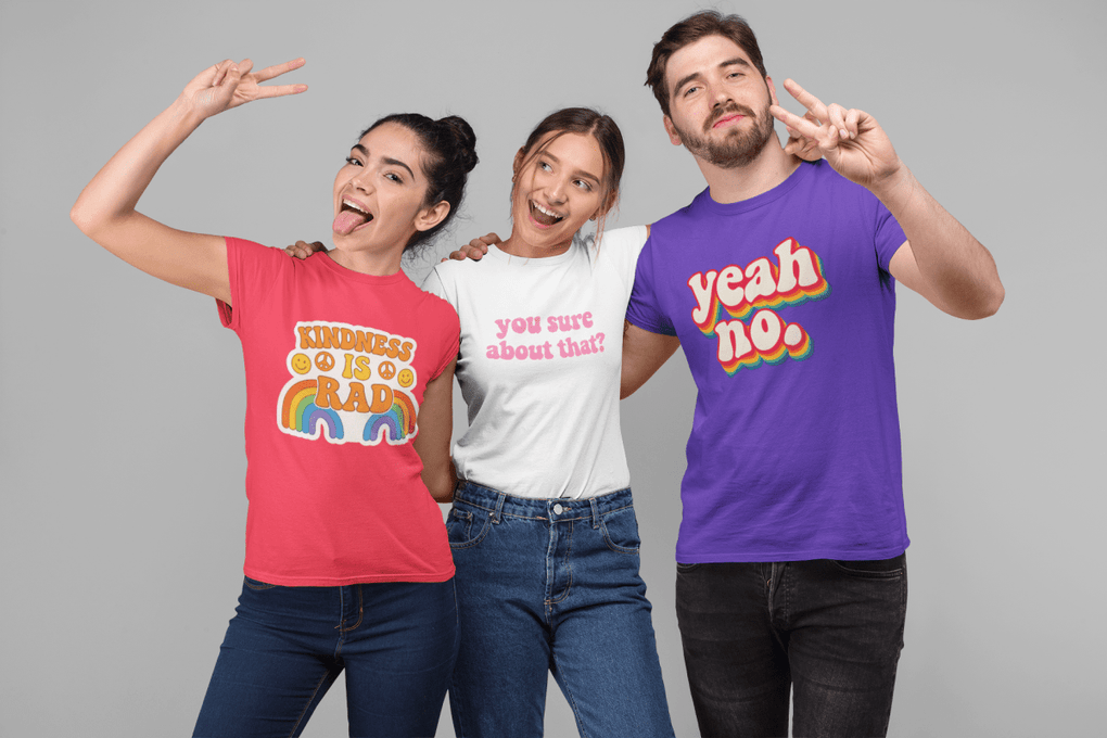 Three people wearing colorful t-shirts with text and designs on a gray background